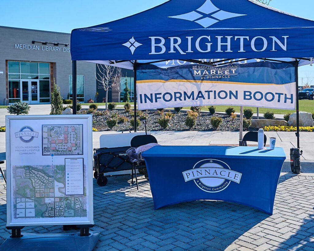 Rogue Graphics examples of custom trade show materials, including custom pop-up tent, custom table cover, and custom flag for local Boise, Meridian and Nampa companies.